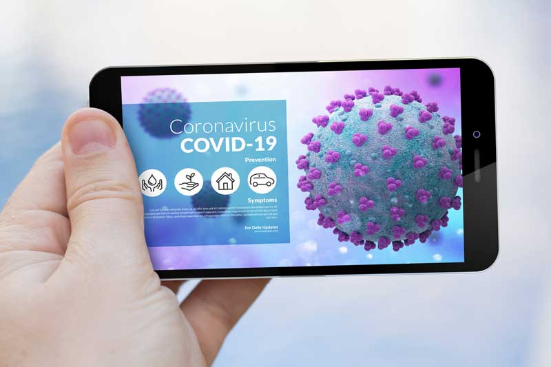 hand holding an iphone showing covid information