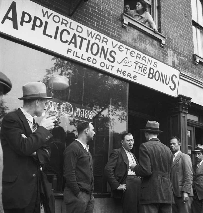 World War Veterans, in black and white, standing in line for applications