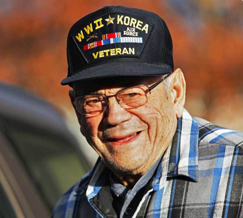 A Korean War Veteran smiles at the camera