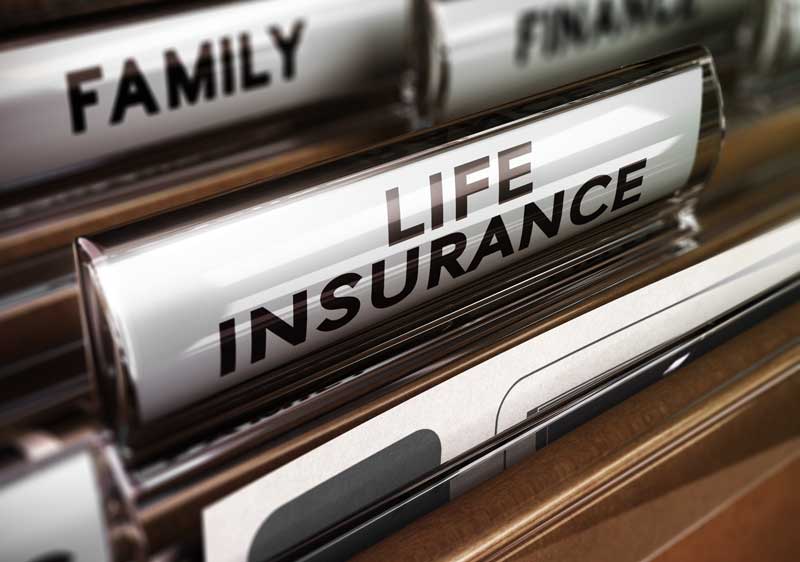 a drawer of file folders with life insurance file highlighted