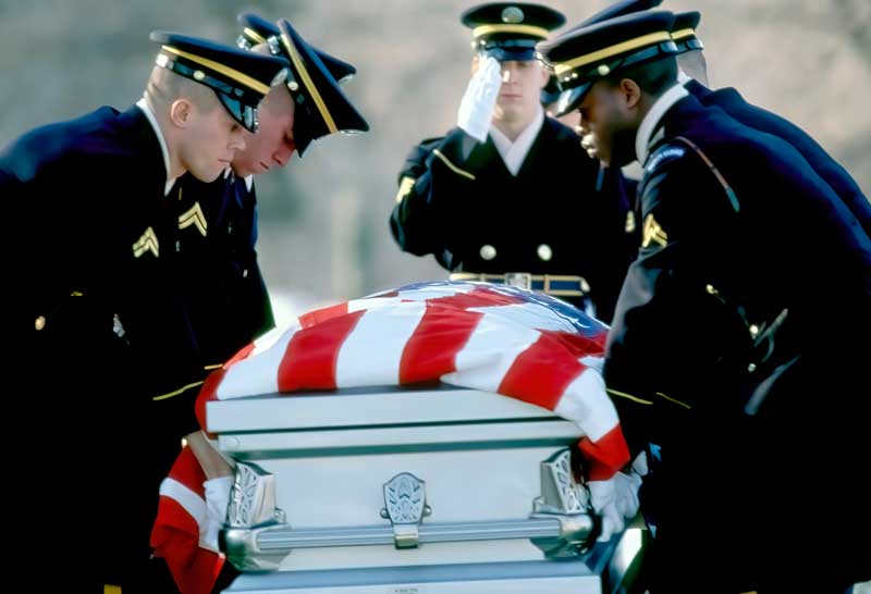 officers carry a coffin for a fallen soldier