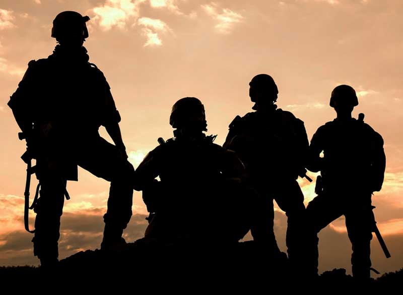 Military service members, pictured in shadow
