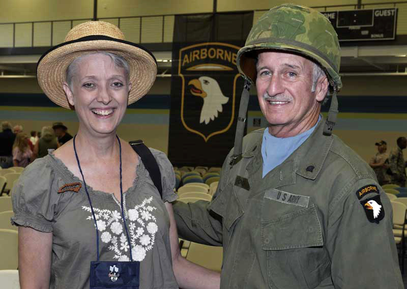 older military couple smiles at camera