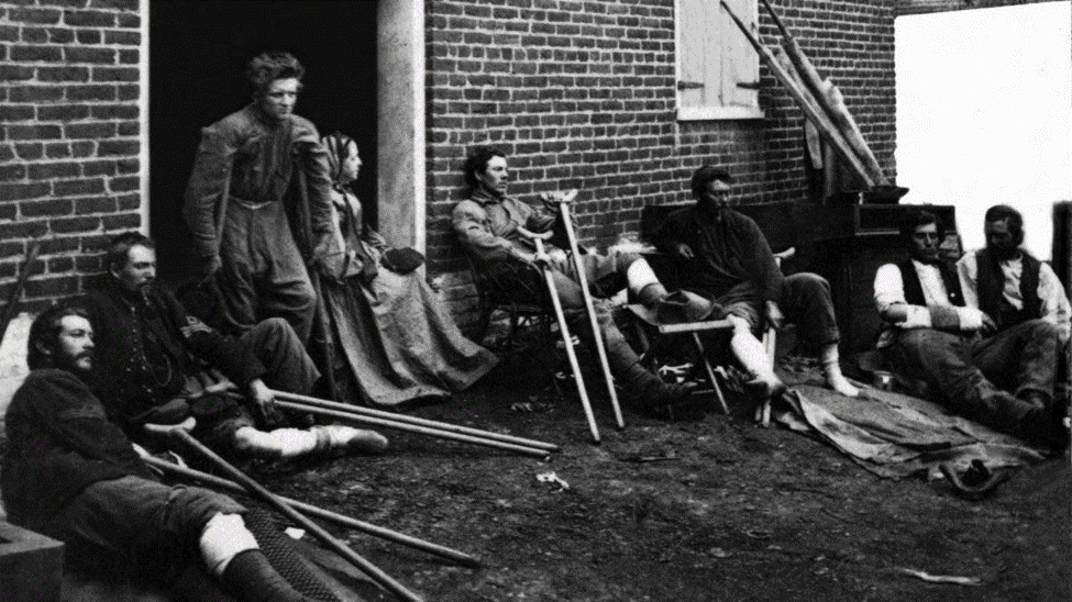 WHY VA? The History of VA and its Legacy of "Serving Those Who Served" Wounded soldiers outside a hospital in Fredericksburg Virginia 1864