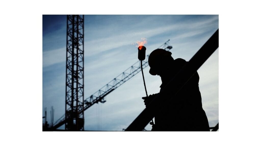 Construction worker who could be working with 100% disability rating, in shadow, shown on a job site.