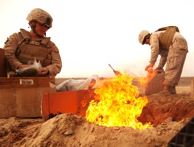 service members working near a flame