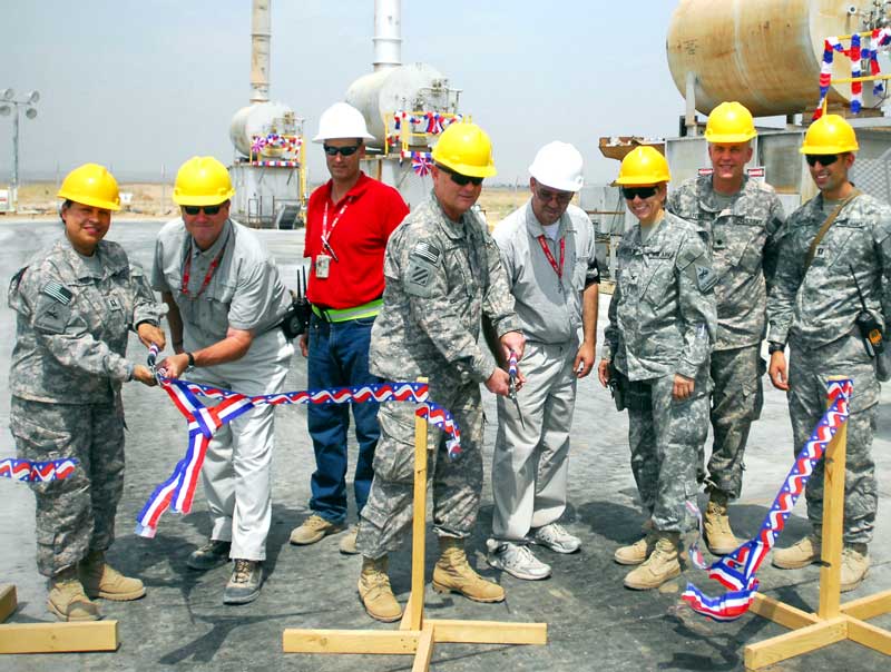 service members cutting patriotic ribbon