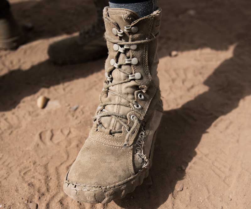 An active duty soldier's boots tied tightly