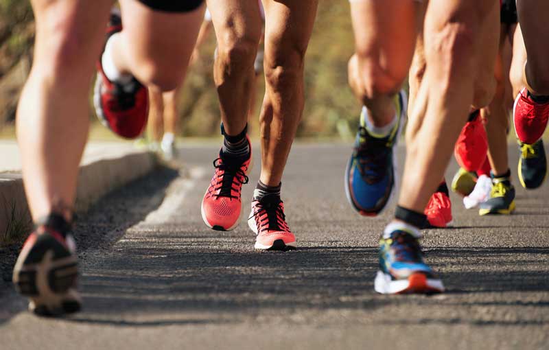 The feet and legs of group of veterans running a 5K