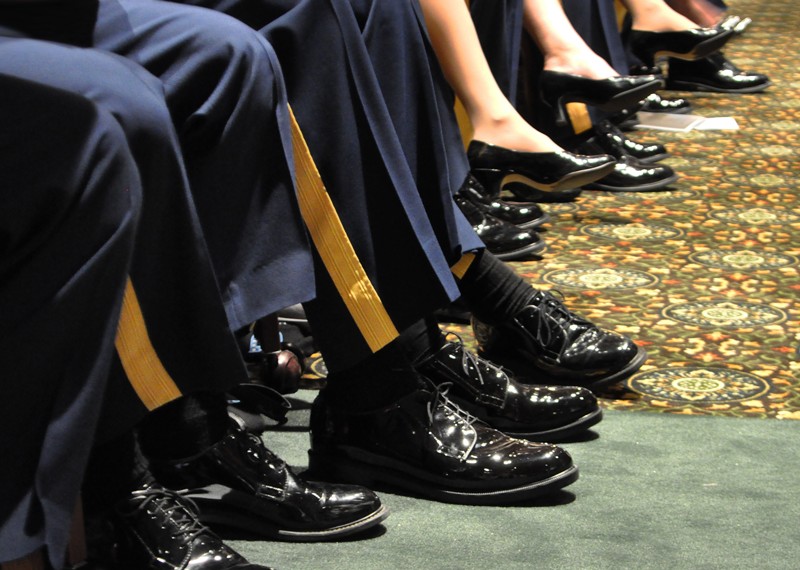 Legs and feet of soldiers wearing corframs and black dress shoes.